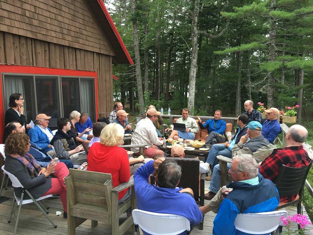 large group of people sitting outside on patio