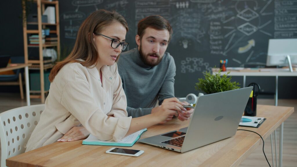 a 35 - 40 year old couple looking at their finances in June for a mid-year check-in remotely with their fiduciary